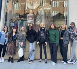 Leeds City College students beside their sustainable fashion window display at John Lewis