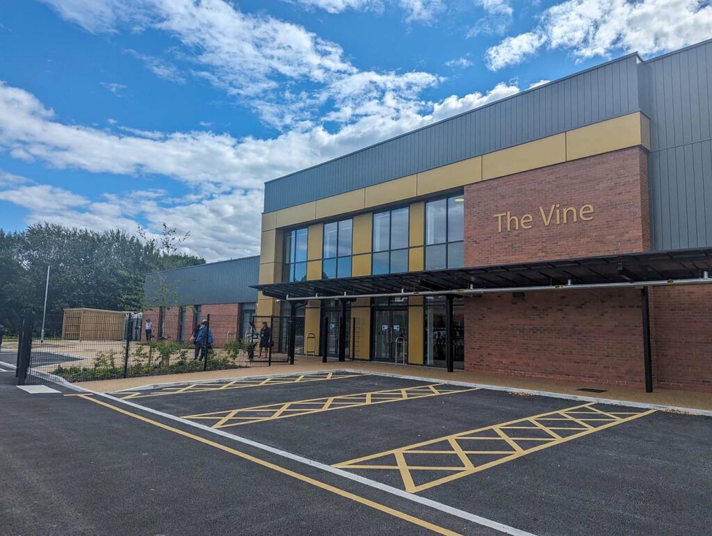 The front of the Vine building, shown with spacious parking at the front