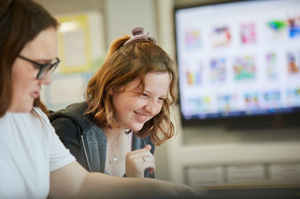 Two students on a child education course doing arts and crafts