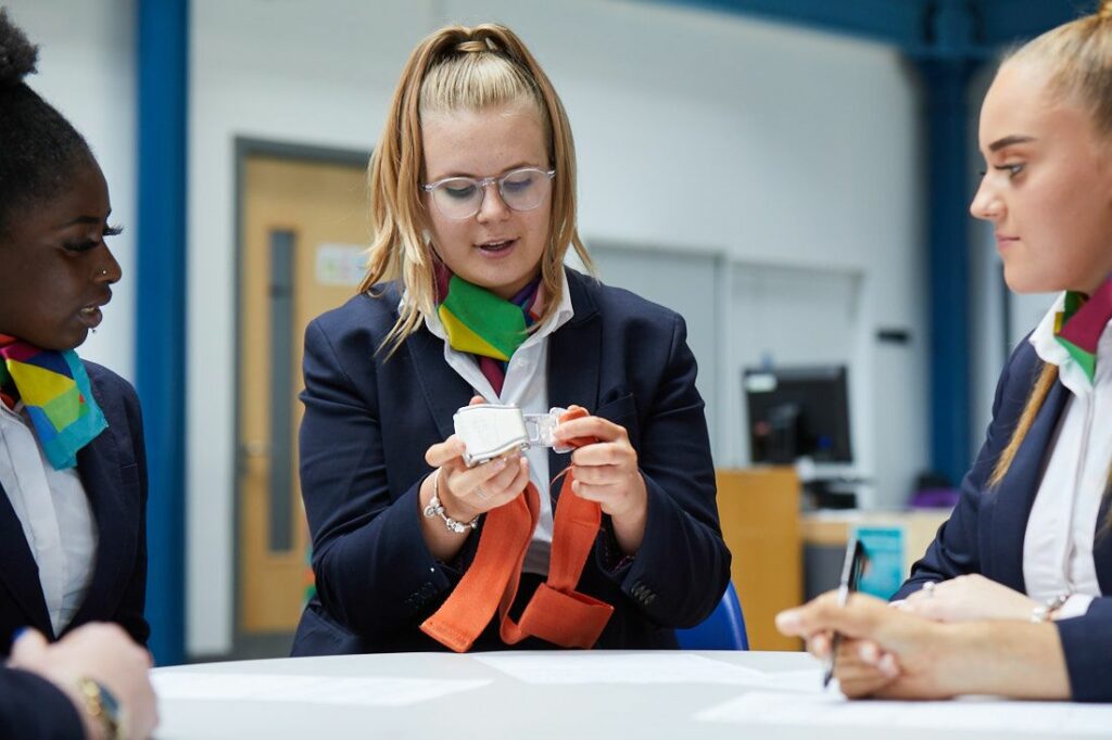 LCC Travel and tourism students going over the safety announcements cabin crew give before flight