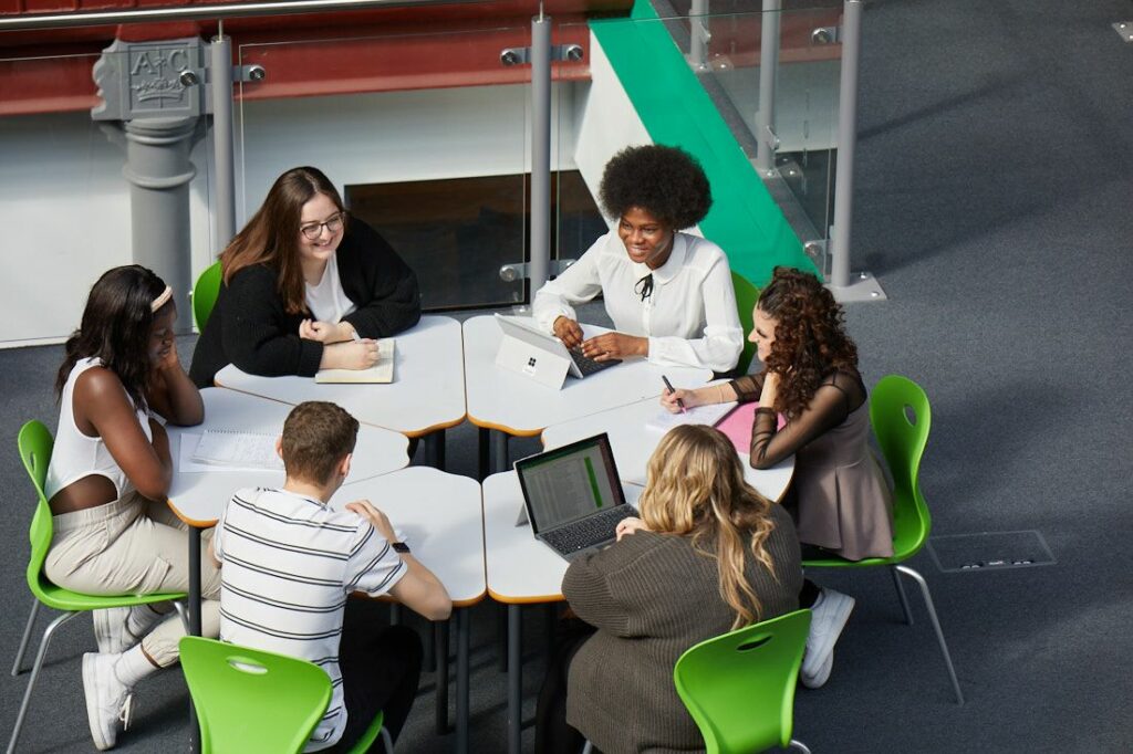 LCC Business students sat round a table sharing ideas and taking notes