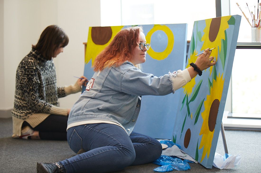 LCC Creative arts, Art and Design students painting sunflowers on to canvas