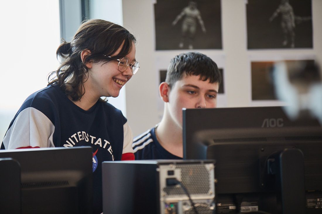 Two LCC creative arts students working in a computer