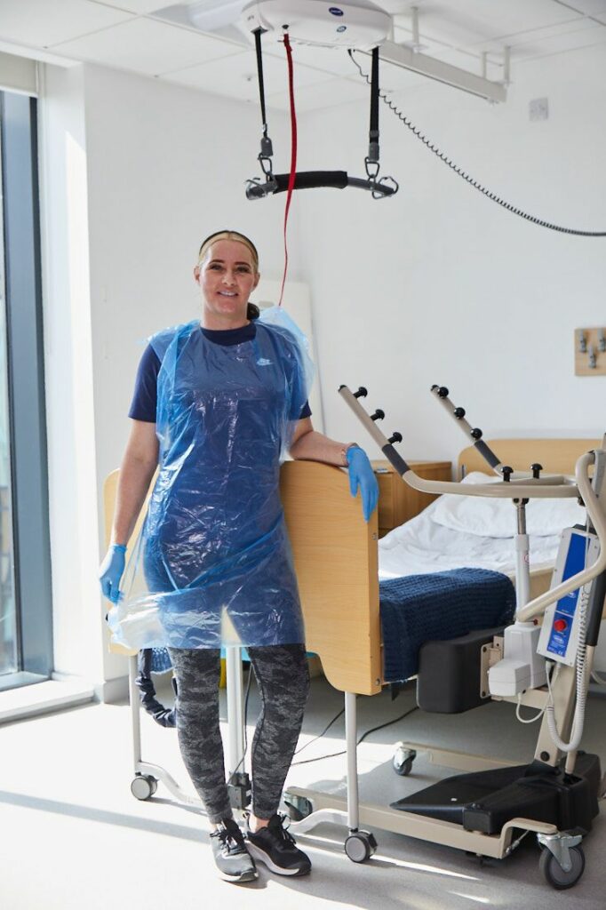 LCC Health Science student in protective clothing in a hospital room