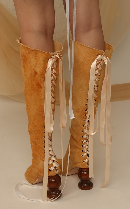 Close up of woman's legs in tan suede lace-up boots