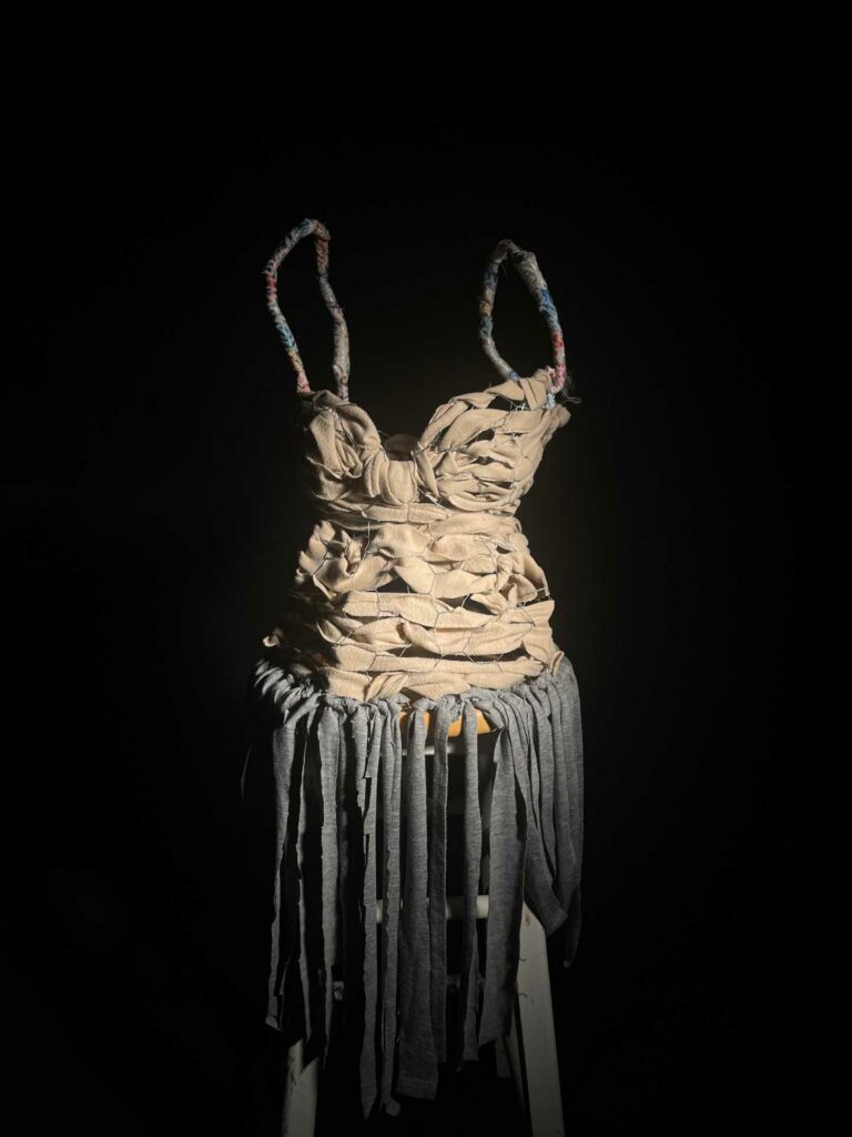 LCC HE Arts students floating dress made from what appears to be thick ribbon fabric and metal wire fencing