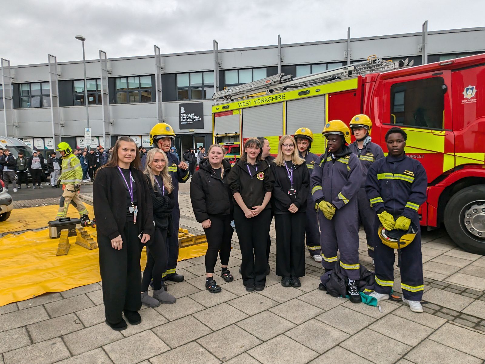 students standing in front of fire engine in printworks carpark