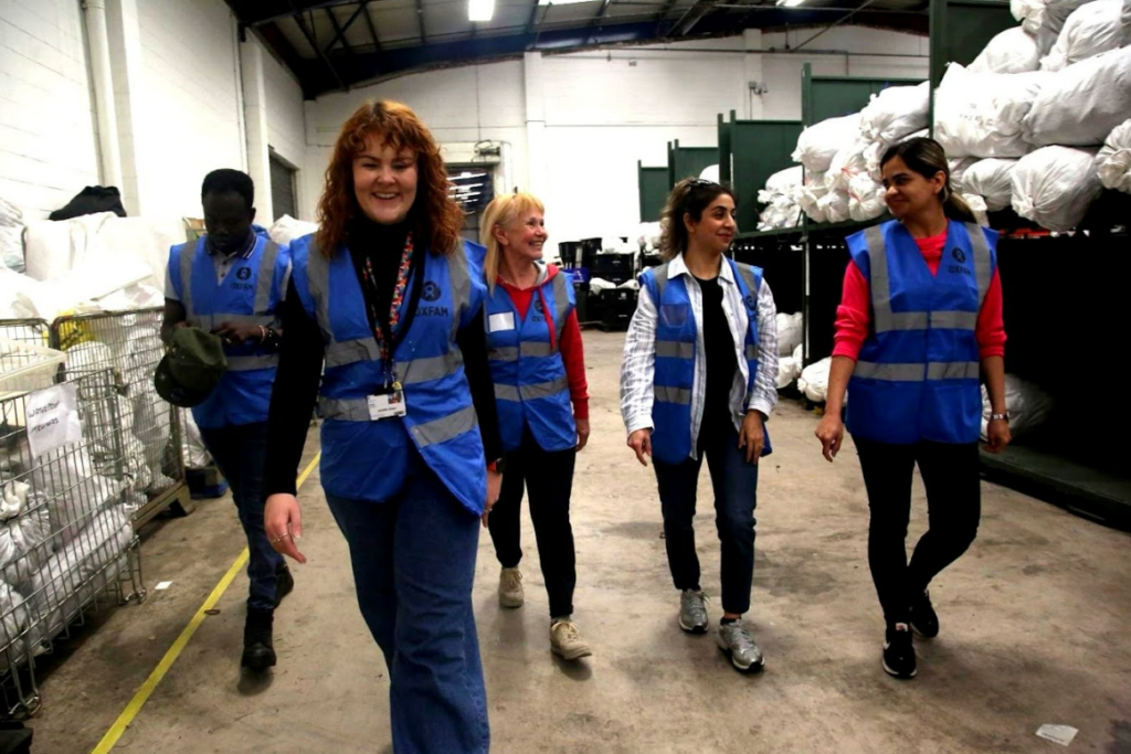 A group of adult students walking in a warehouse together