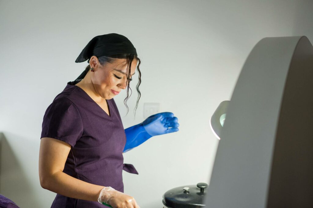 A female hair and beauty student wearing protective gloves preparing a treatment solution