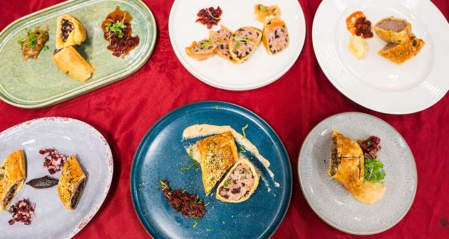 Plates of food ready to be served on a red tablecloth in the Printworks Kitchen and Bar restaurant
