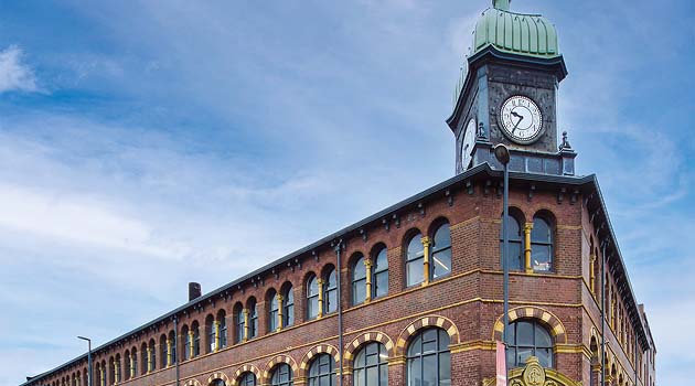 Printworks clock tower with blue sky in the background