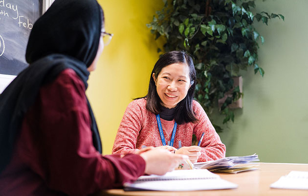 Two adult learners studying in the Enfield Centre building