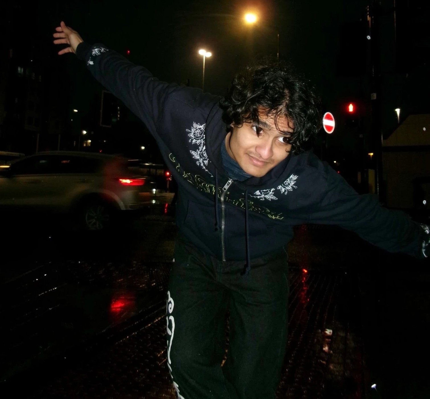 T Level student Vedant Shukla striking a pose on a night-time street