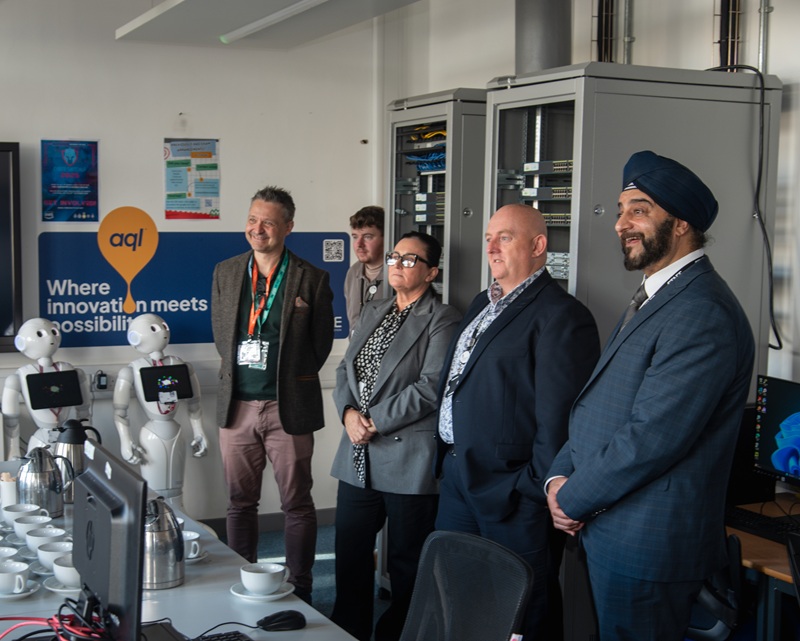 Senior leaders from Leeds City College and representatives from aql nside the new aql Innovation Academy room at Printworks Campus