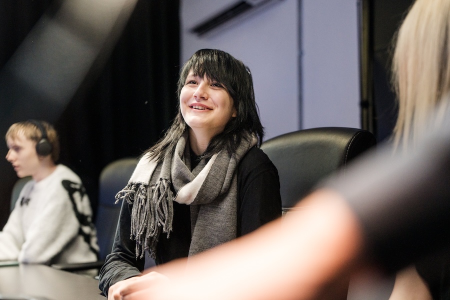 Media students in the studio talking and smiling