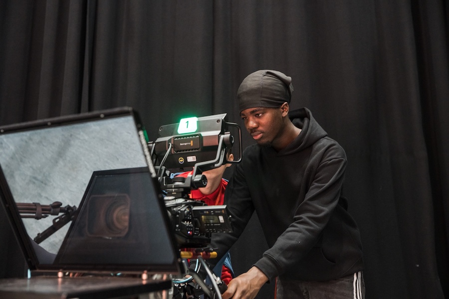 Film student operating the camera moving the the rig to get the shot framed