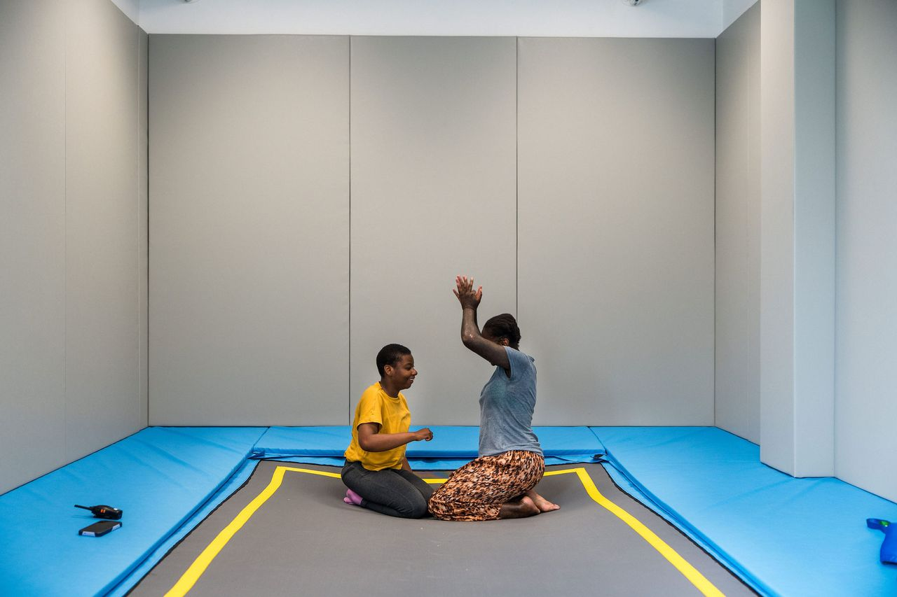 SEND student performing rebound therapy with a teacher