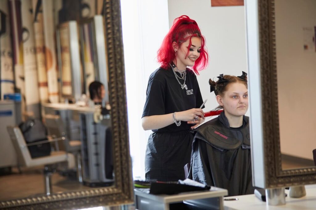 A student hairdresser working in the salon