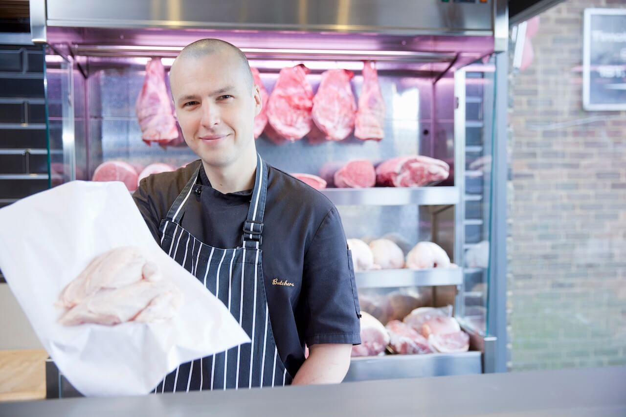 A butcher holding a piece of meat