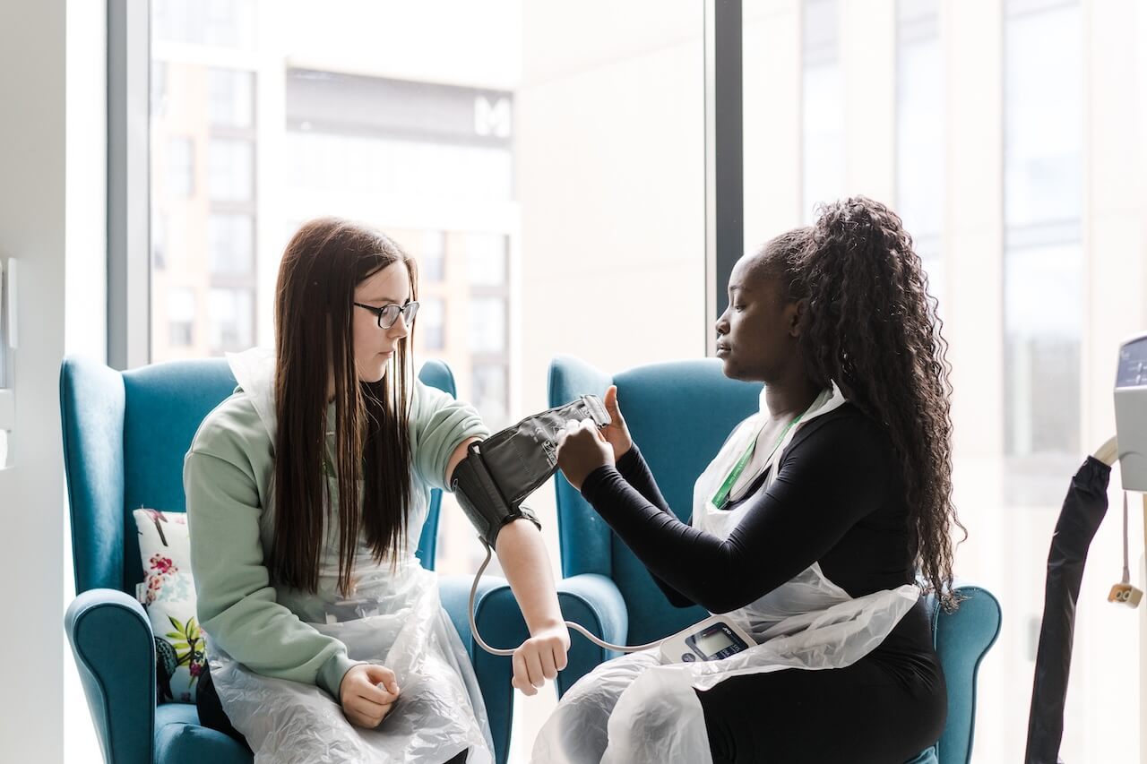 A student taking a patients blood pressure