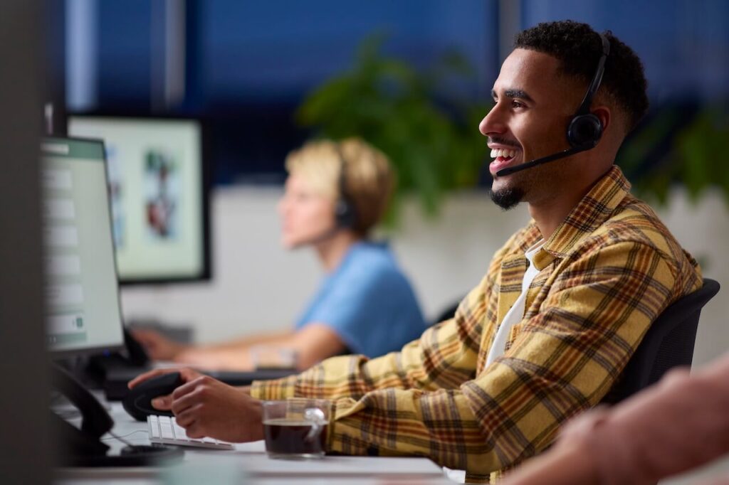 A student workng at a desk, on a computer.