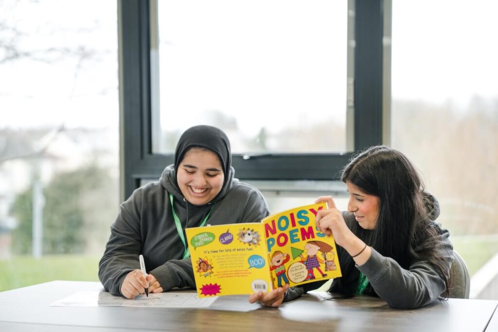 A tutor discussing a book with a student