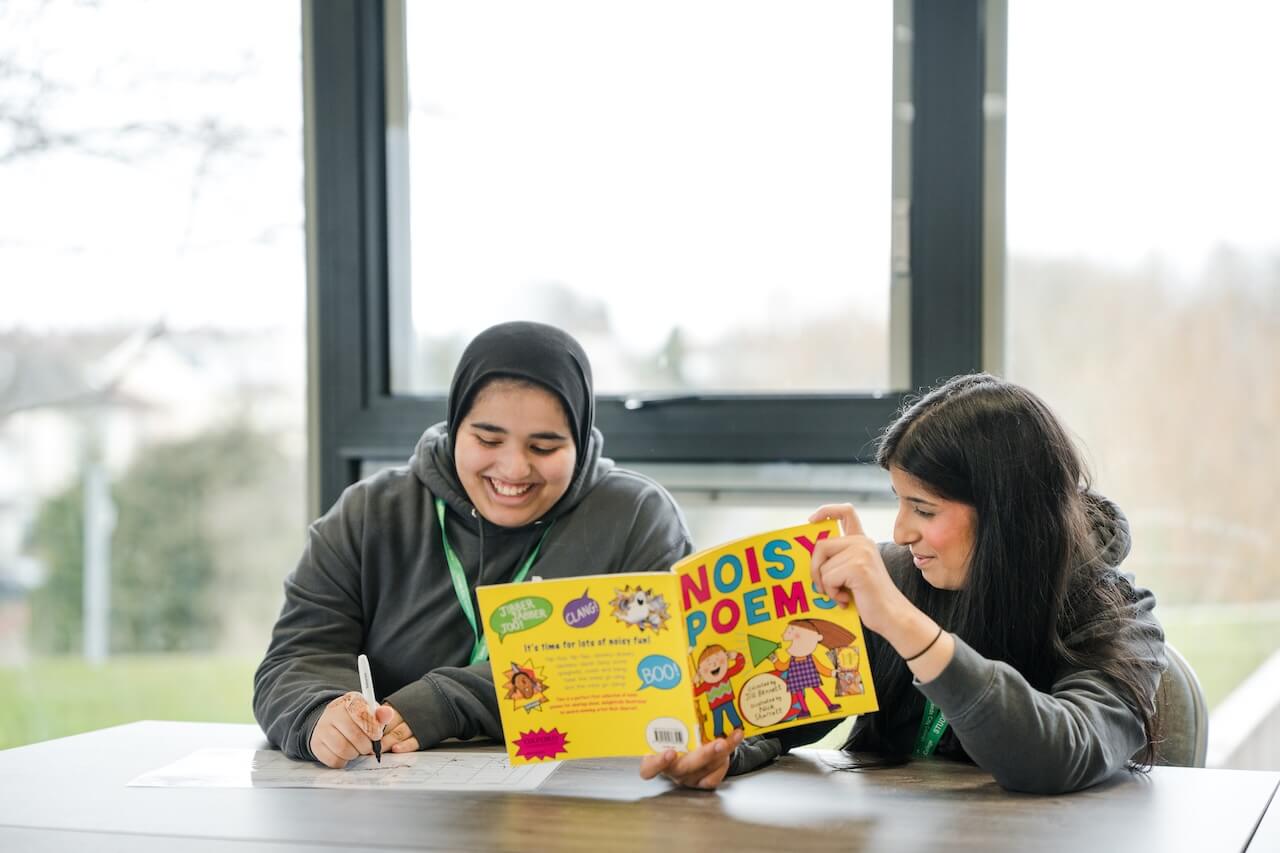 A tutor discussing a book with a student