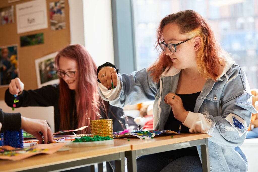 Two students making a arts and crafts piece