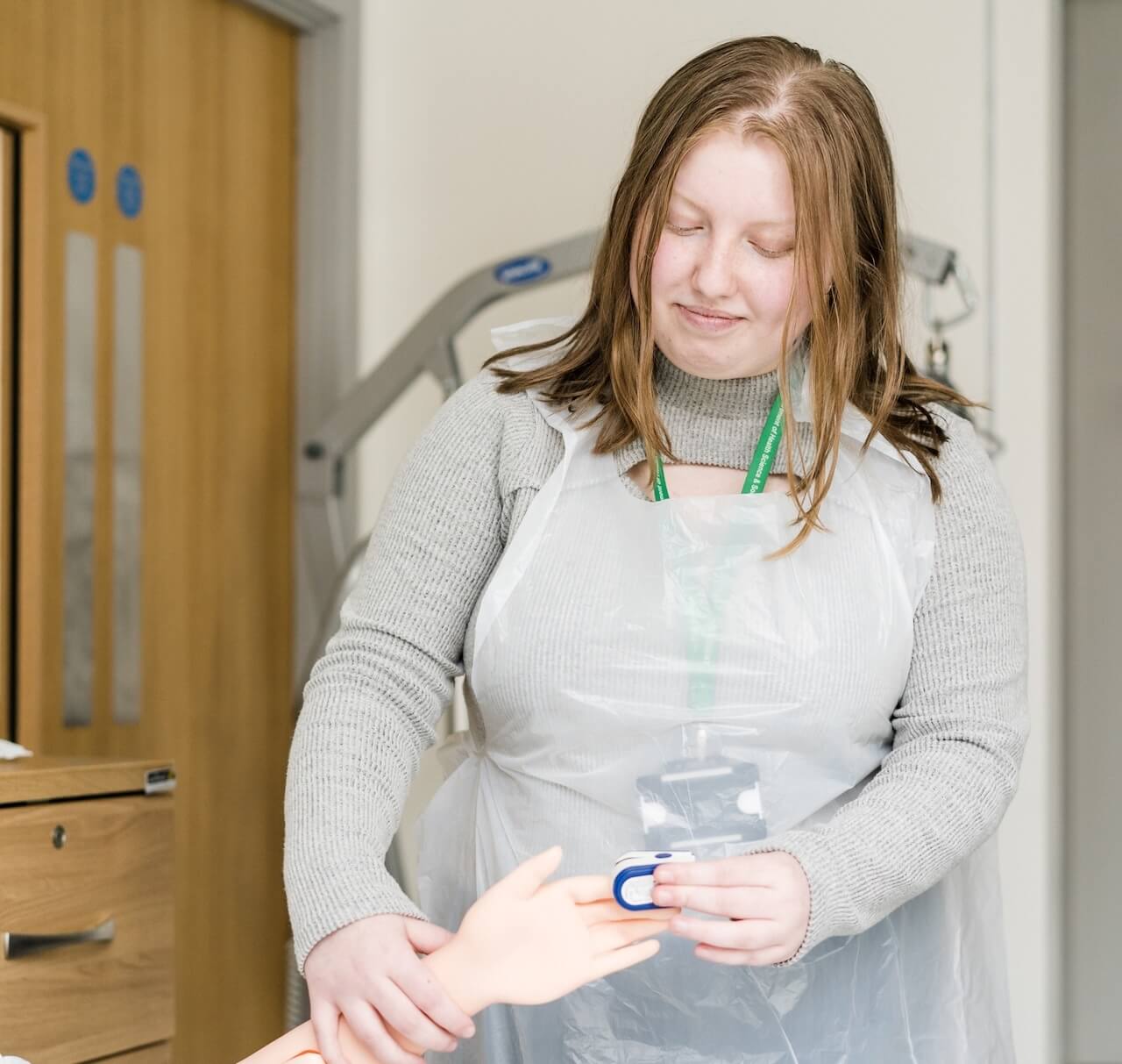 A student practicing on a dummy
