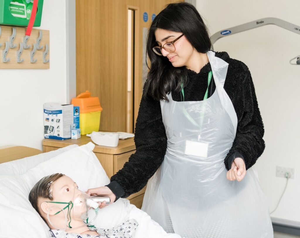 A student practicing on a dummy patient