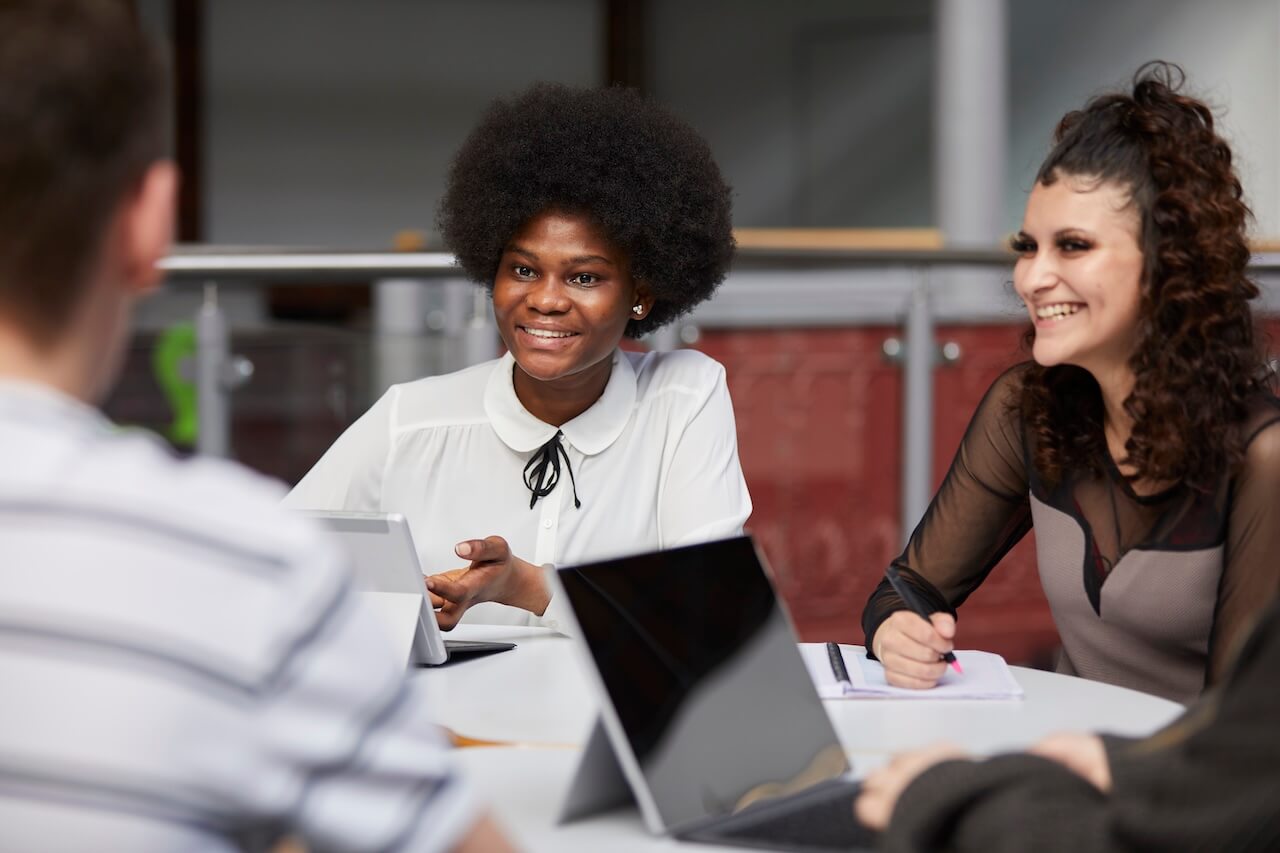 3 young professionals meeting around a table