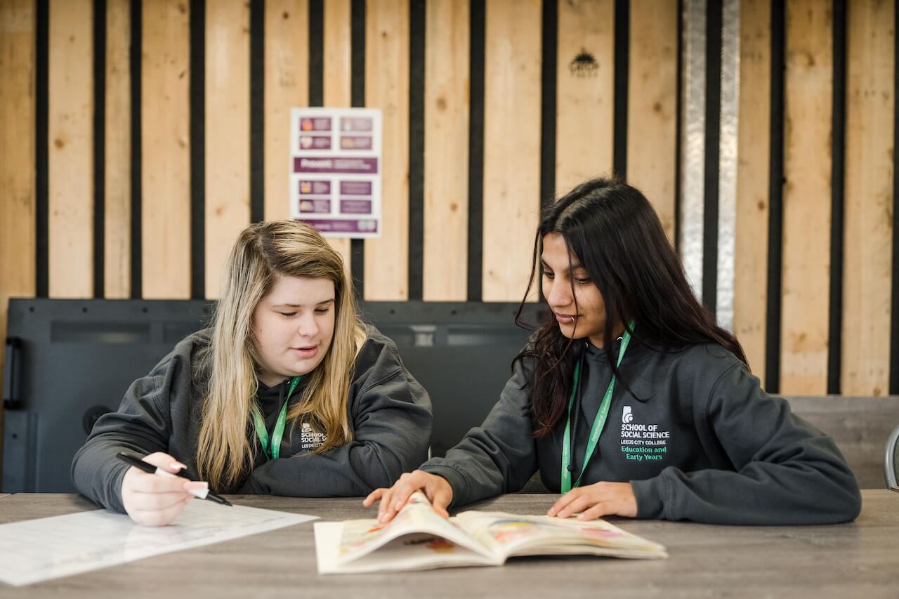 A tutor explaining something to a student