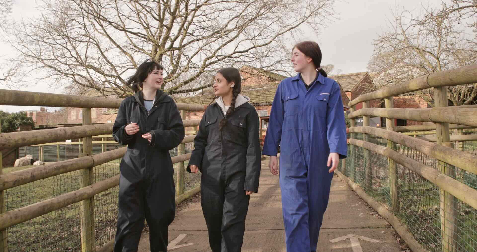 Three Animal Care and Land Management students wearing the college branded PPE overalls