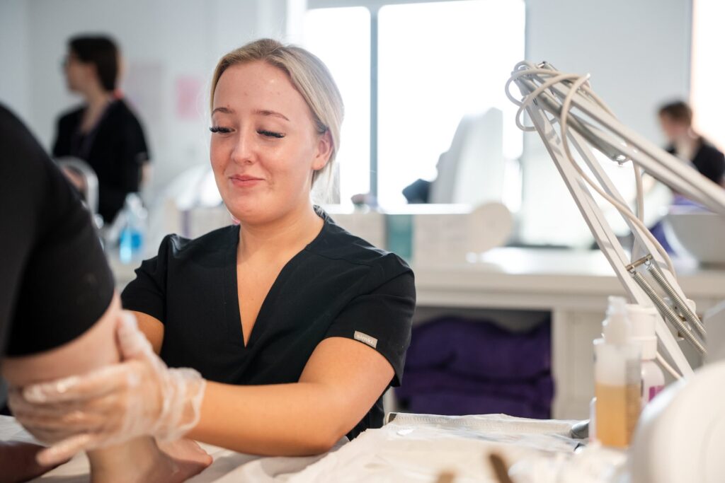 Beauty therapy student doing a pedicure for a client