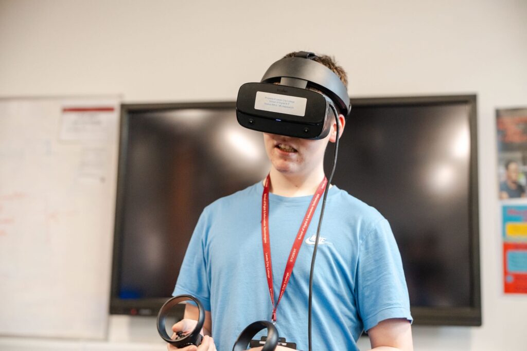 Digital and IT student wearing a VR headset with motion controllers