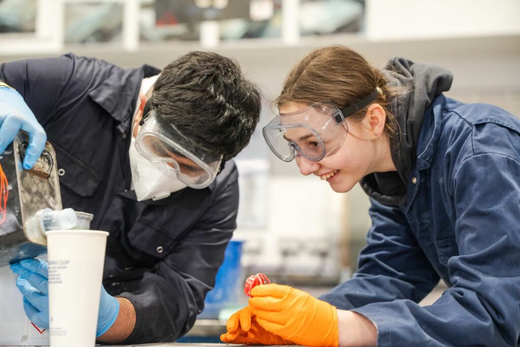 Two Motor Vehicle students mixing the paint used for the spray gun