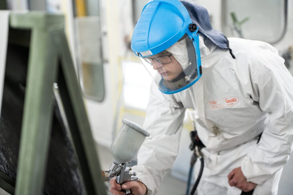 Motor Vehicle student using a spray gun to paint a car