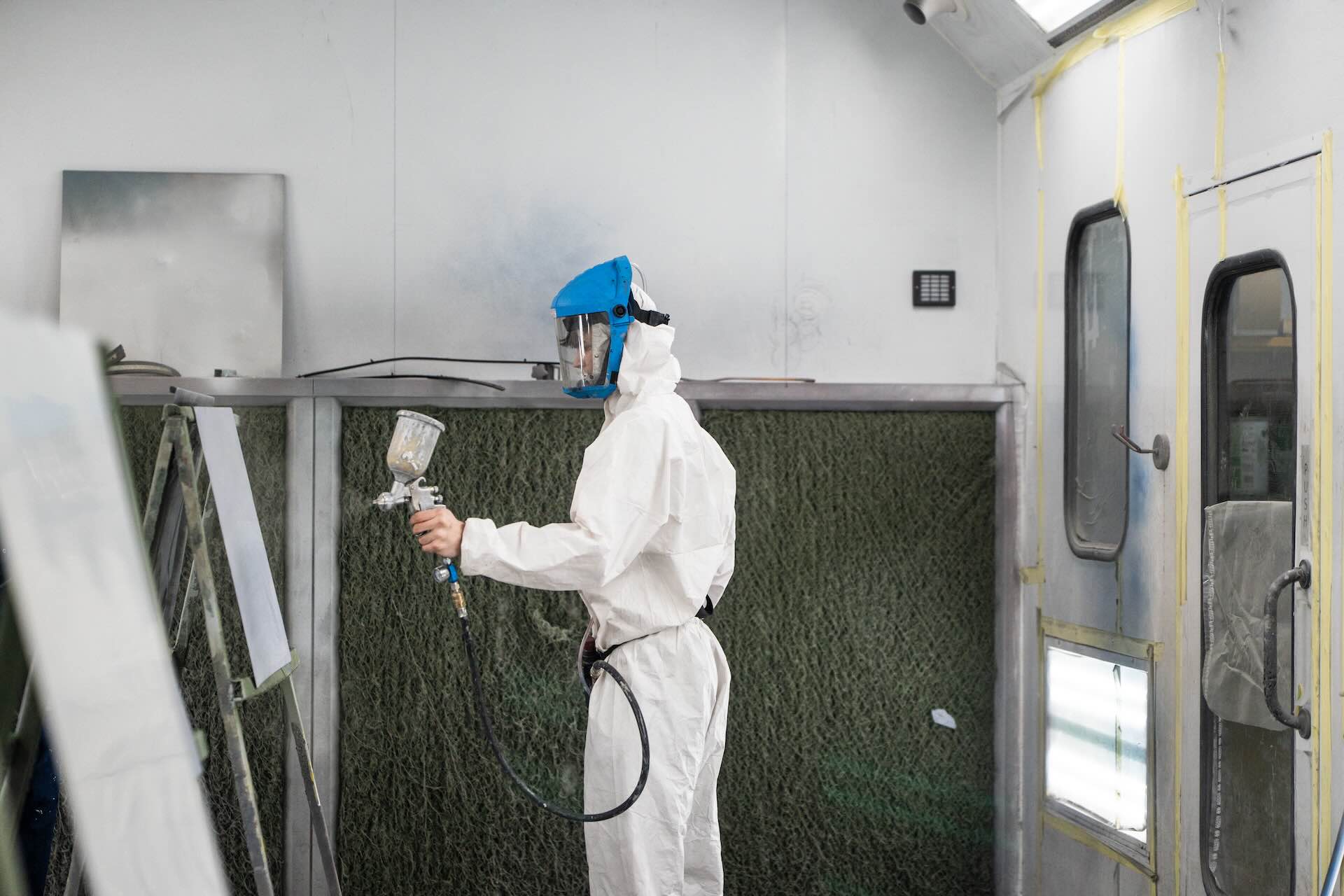 Motor Vehicle student using a spray gun to paint a car