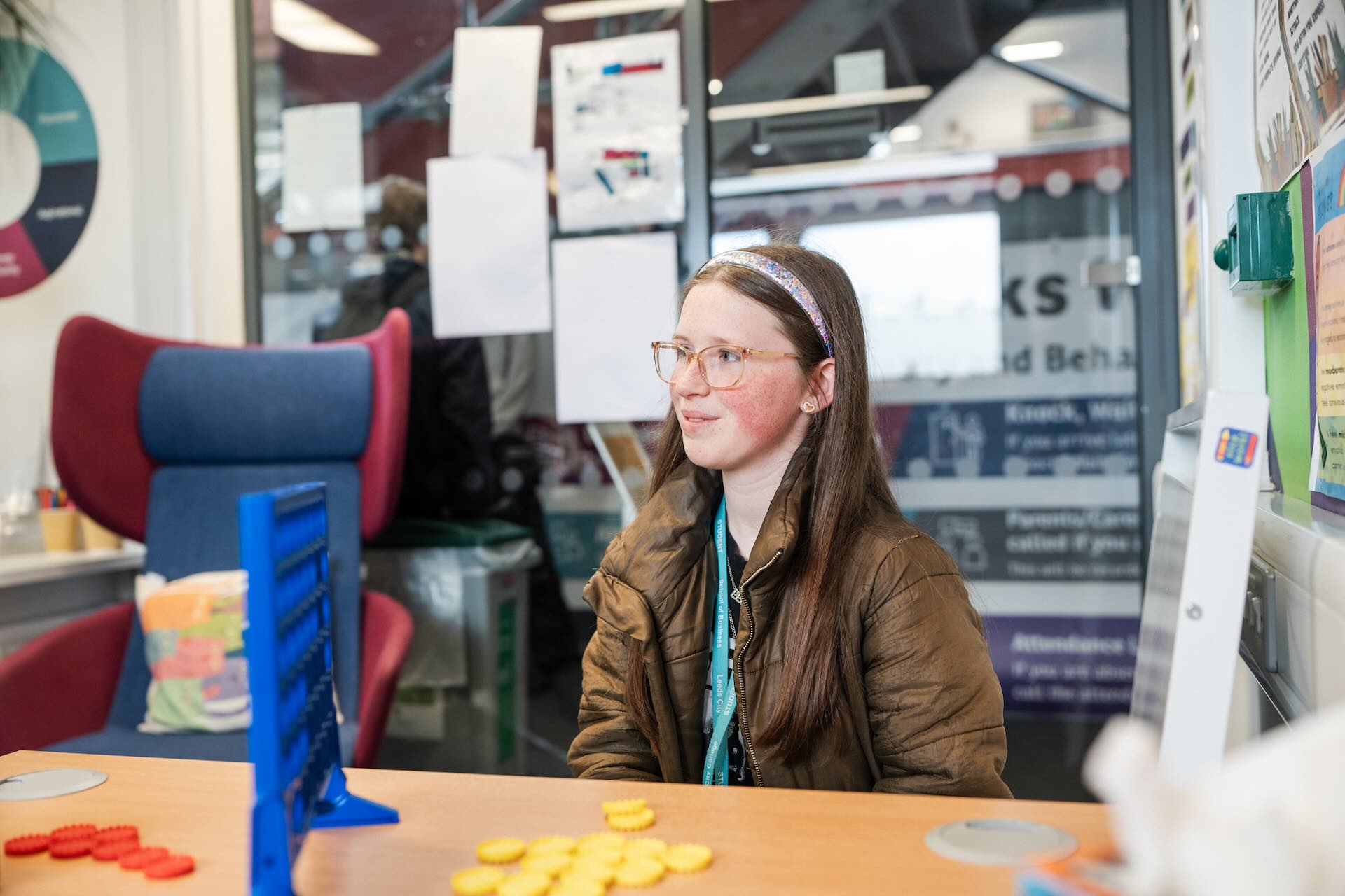 A student is in the well-being room playing connect four