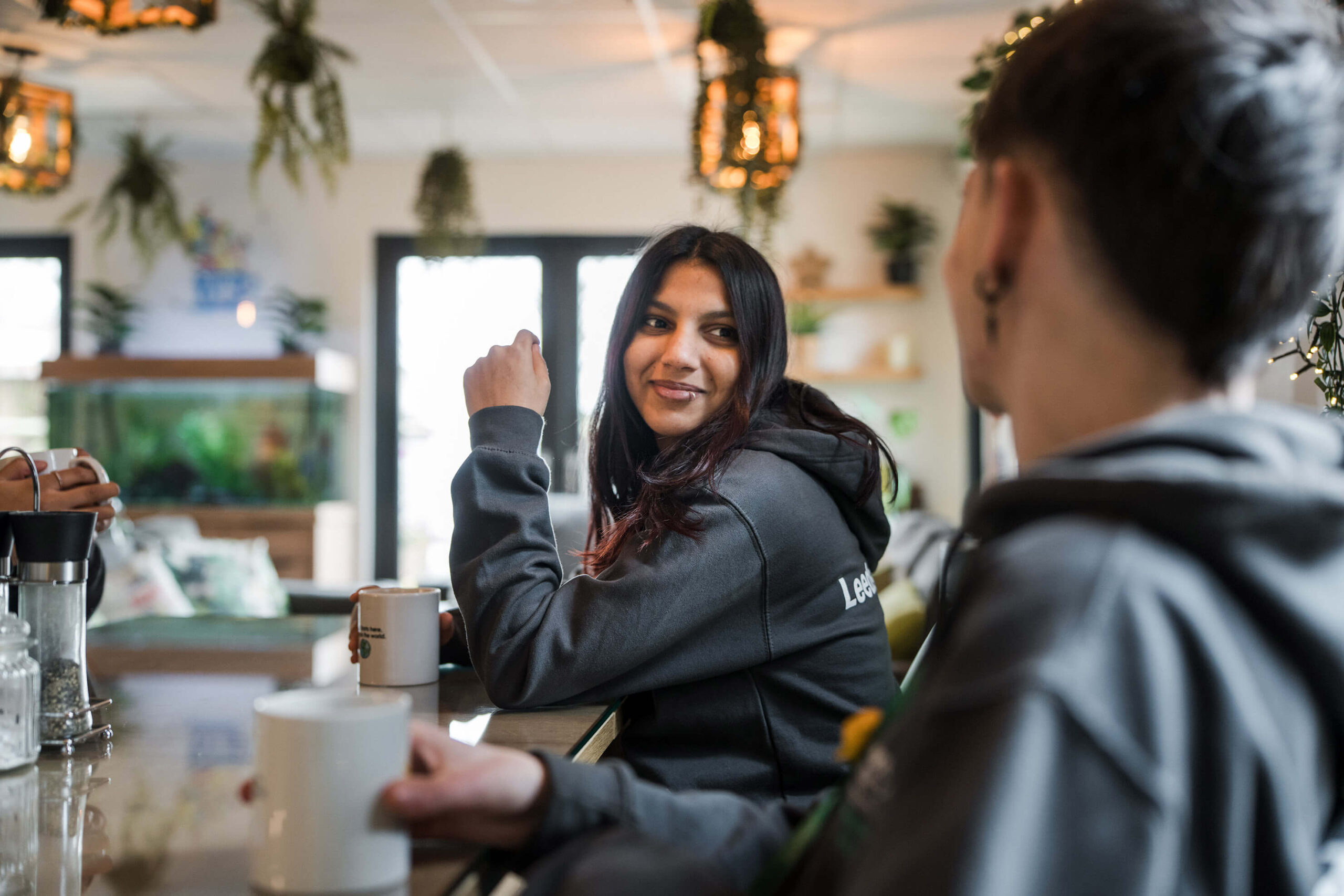 Two students having a conversation over coffee