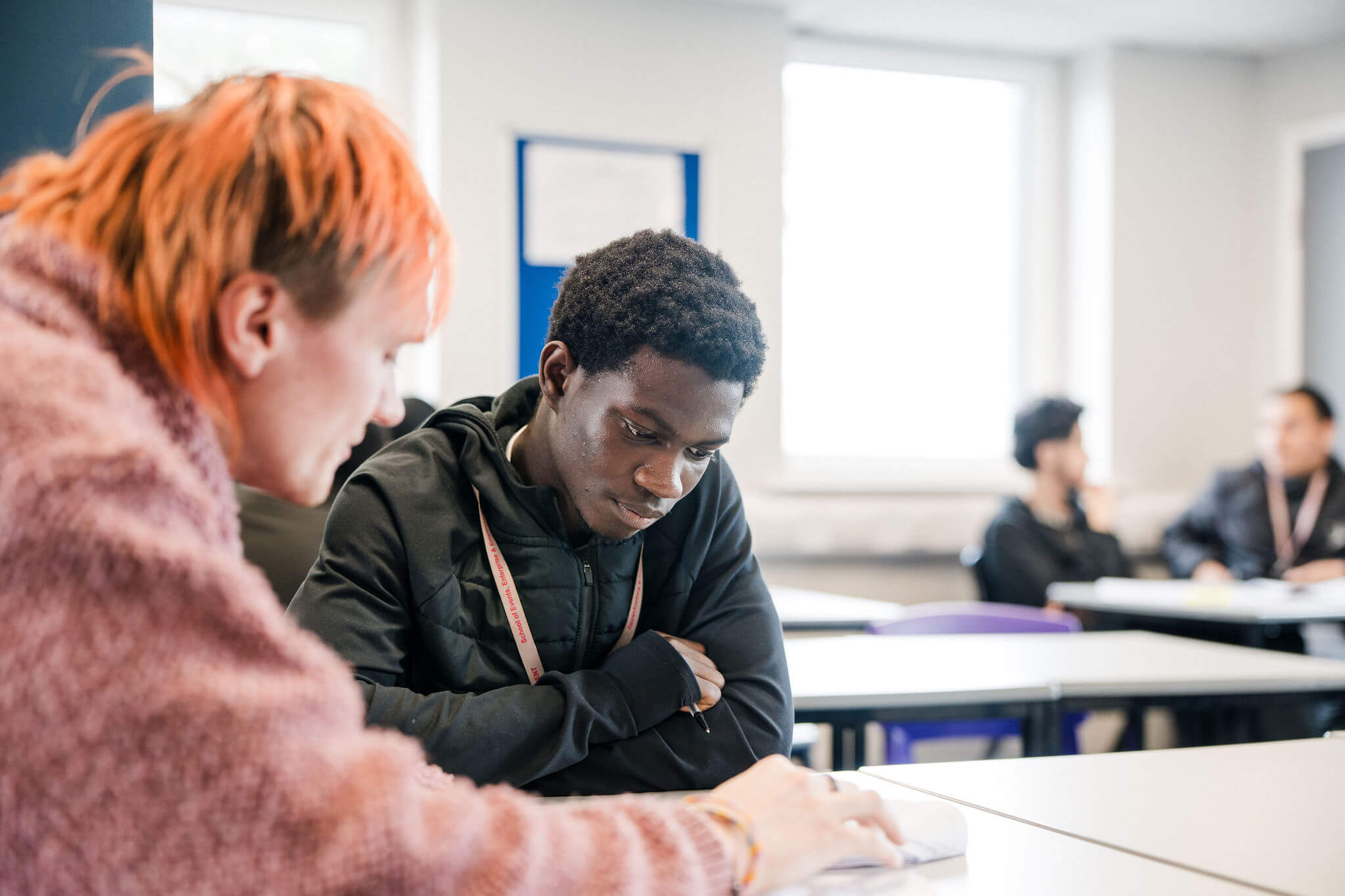A tutor explaining something to a student