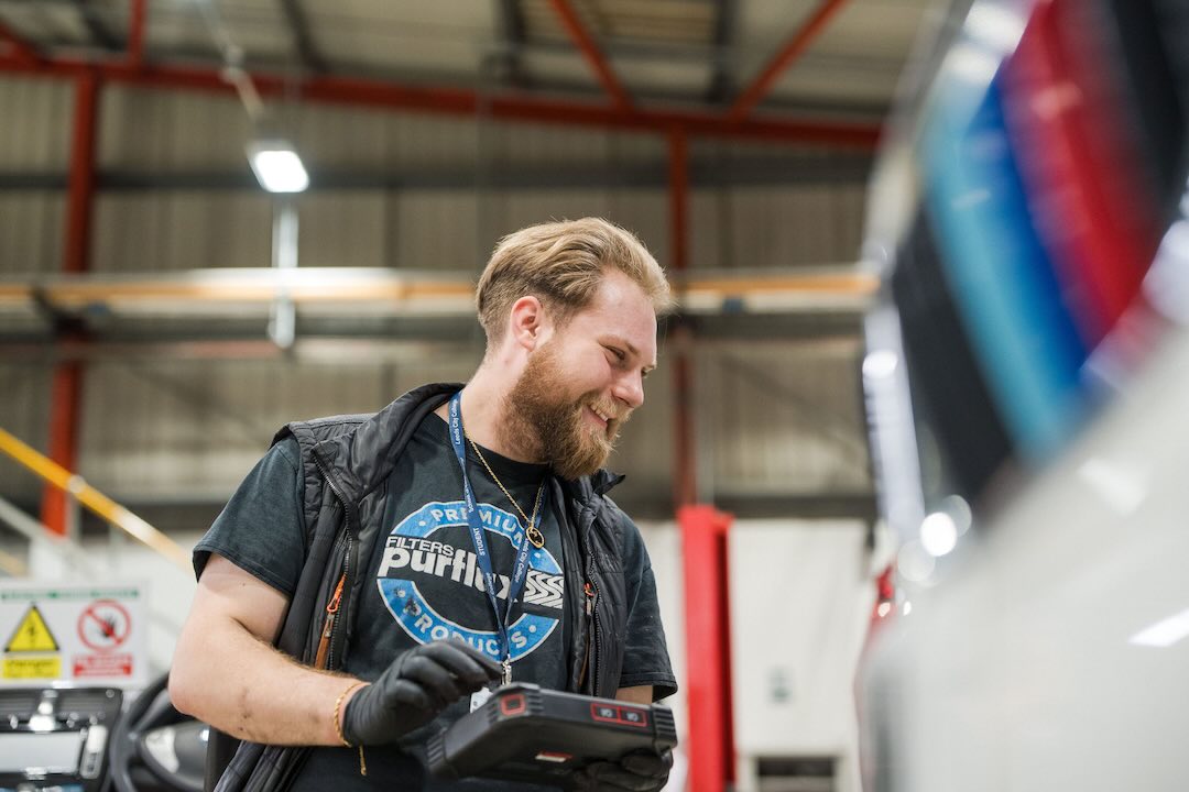 LCC Motor vehicle teacher using a diagnostics tool on the car