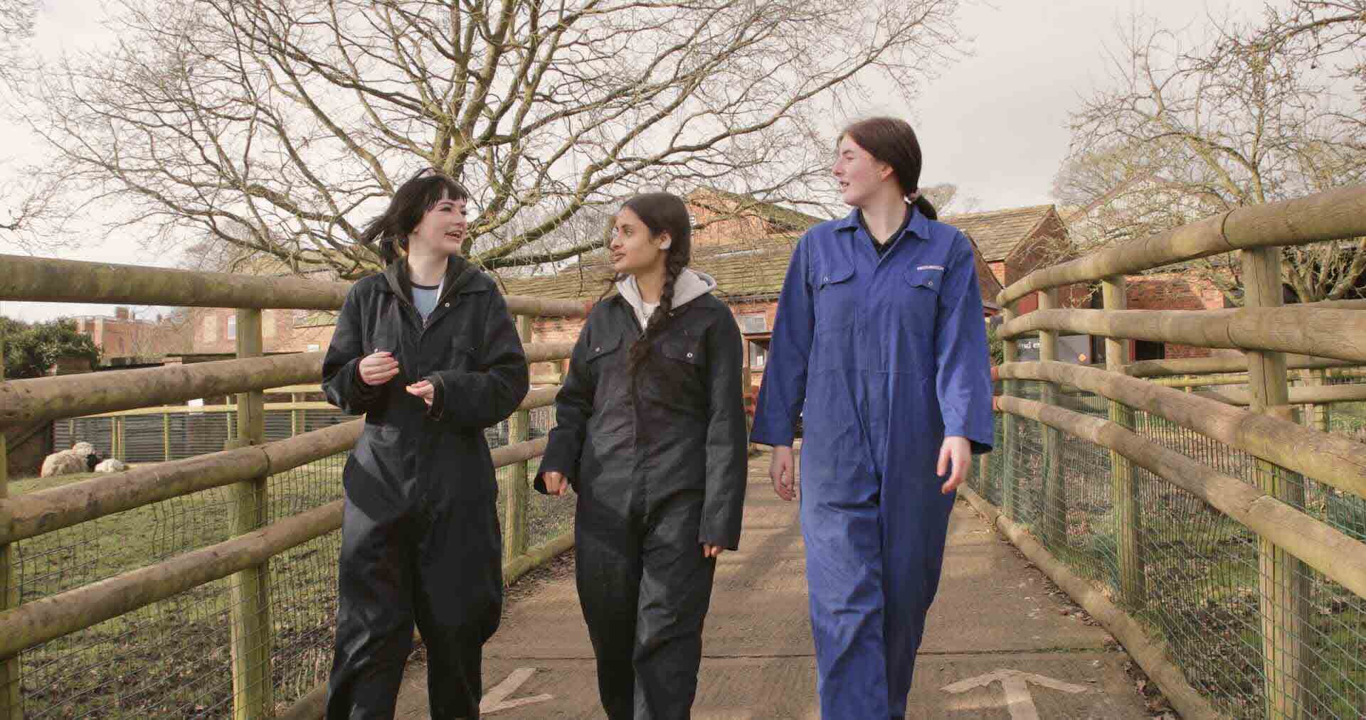 Three Animal Care and Land Management students wearing the college branded PPE overalls