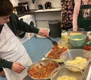 Student cooking and preparing meals in the kitchen