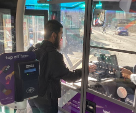 Student paying for a bus ticket on a bus