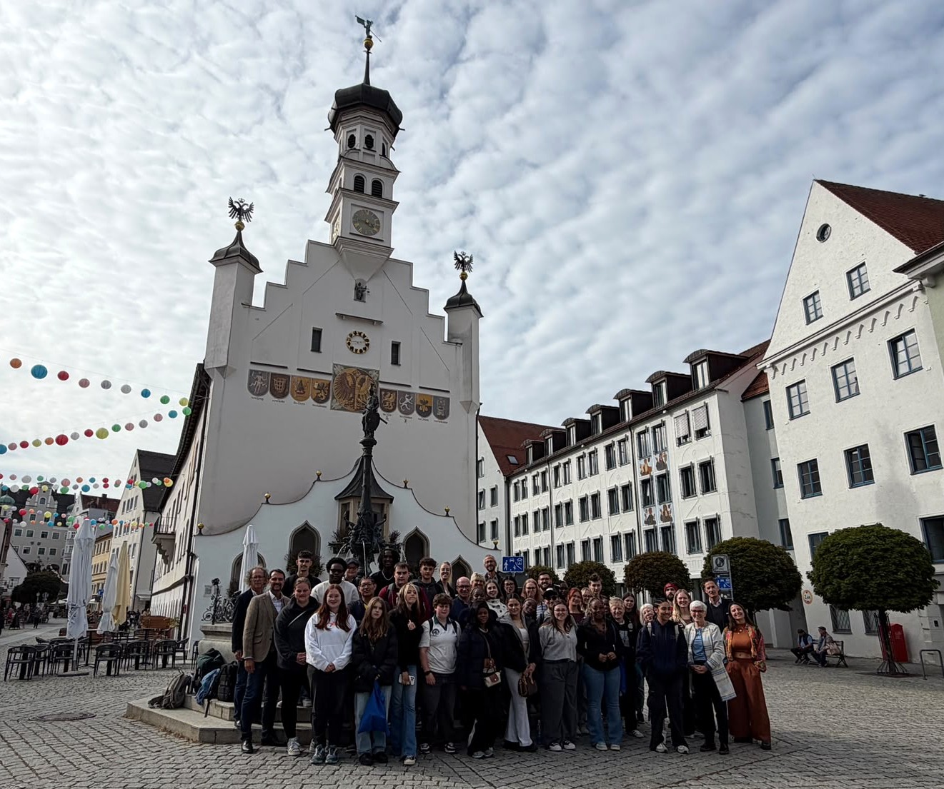A group of Leeds City College students gathered below a clock tower in Kempten, Germany