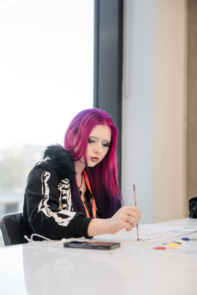 A student using acrylic paints