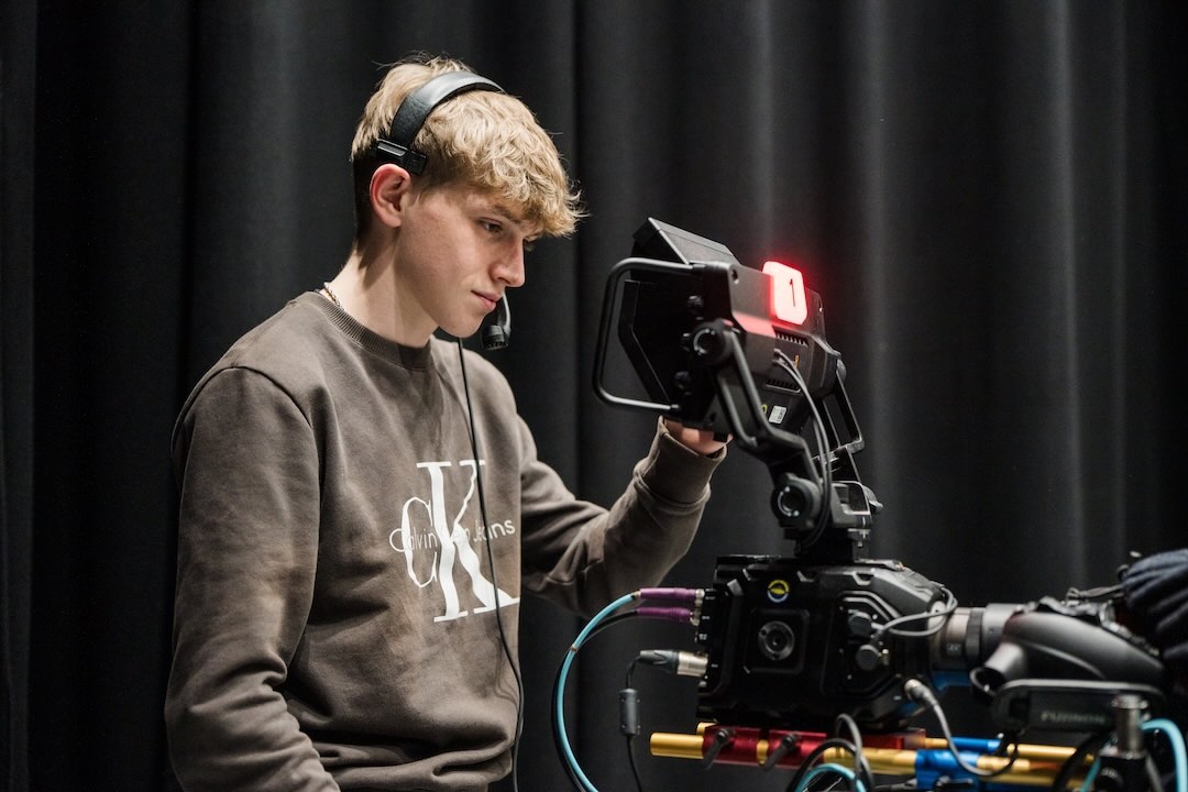 Media student operating a studio camera