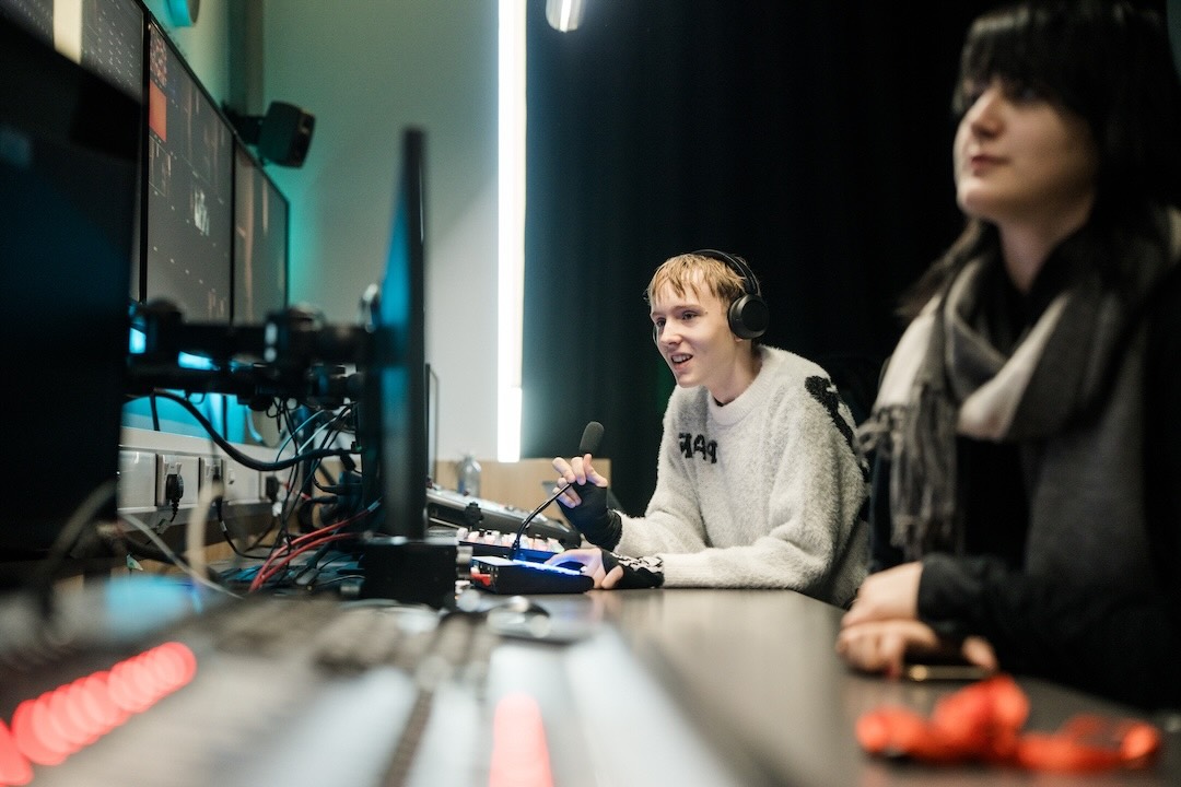 Two media students working the control station for a broadcast