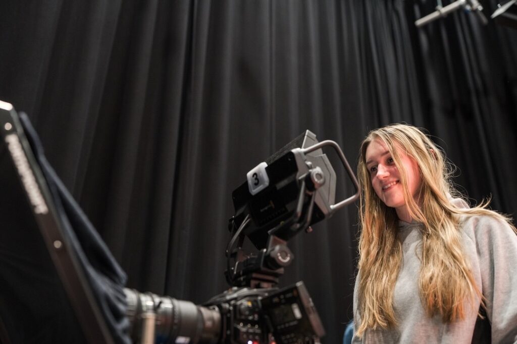 Media student operating the camera in a broadcast